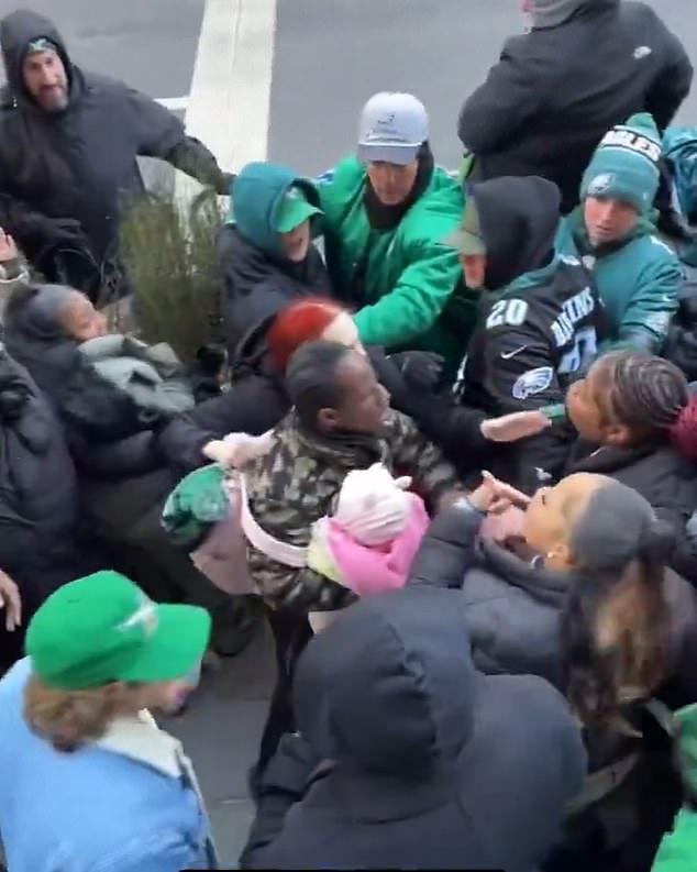 Horrifying moment Eagles fan holding a baby fights with woman during Philadelphia Super Bowl parade