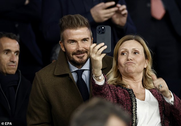David Beckham poses for photos with fans as he watches former side PSG take on Liverpool in Paris Champions League clash